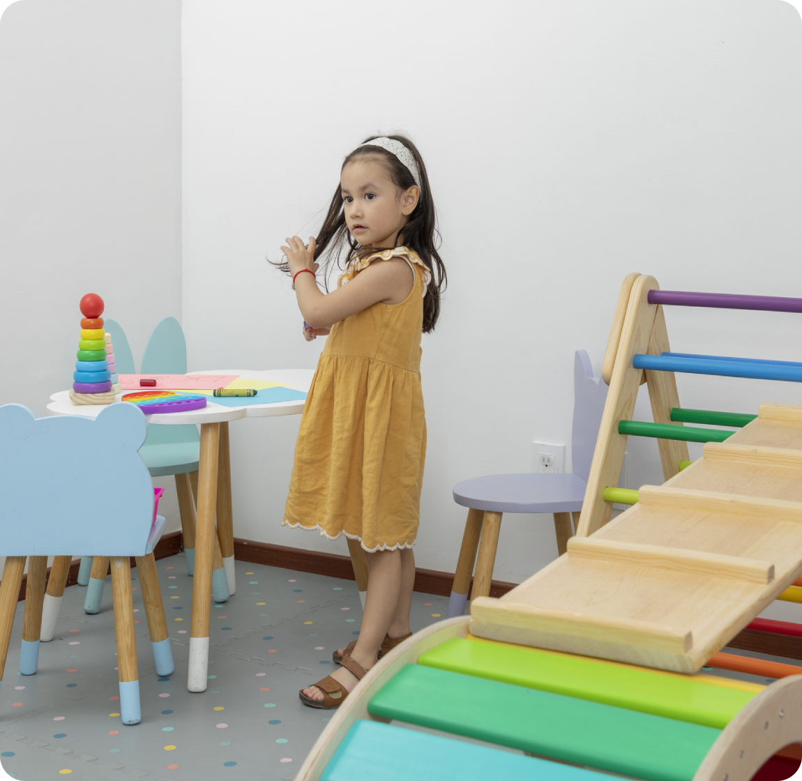 Frame-1618873787 (3) A little girl standing in front of some chairs and tables